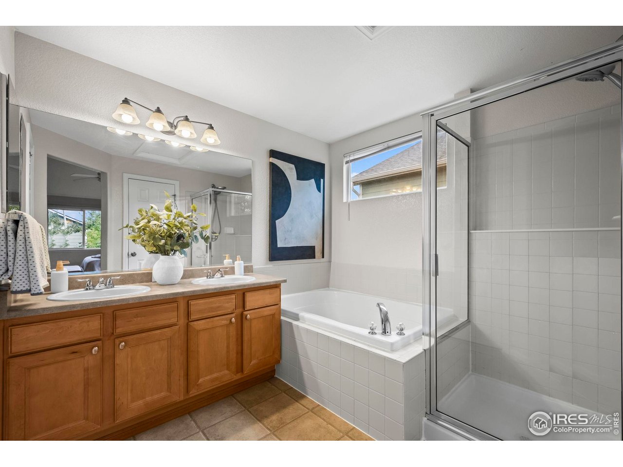 2529 Azalea Way Erie, CO 80516 - Photo 17 of 32 a bathroom with a tub sink and mirror