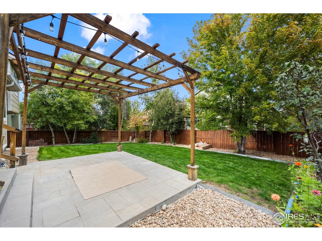 2529 Azalea Way Erie, CO 80516 - Photo 23 of 32 a view of a backyard with a garden and trees