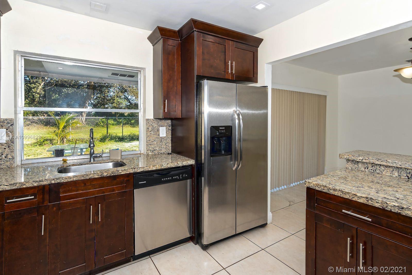 3829 East Shore Road Miramar, FL 33023 - Photo 6 of 14 a kitchen with stainless steel appliances granite countertop a refrigerator and a sink