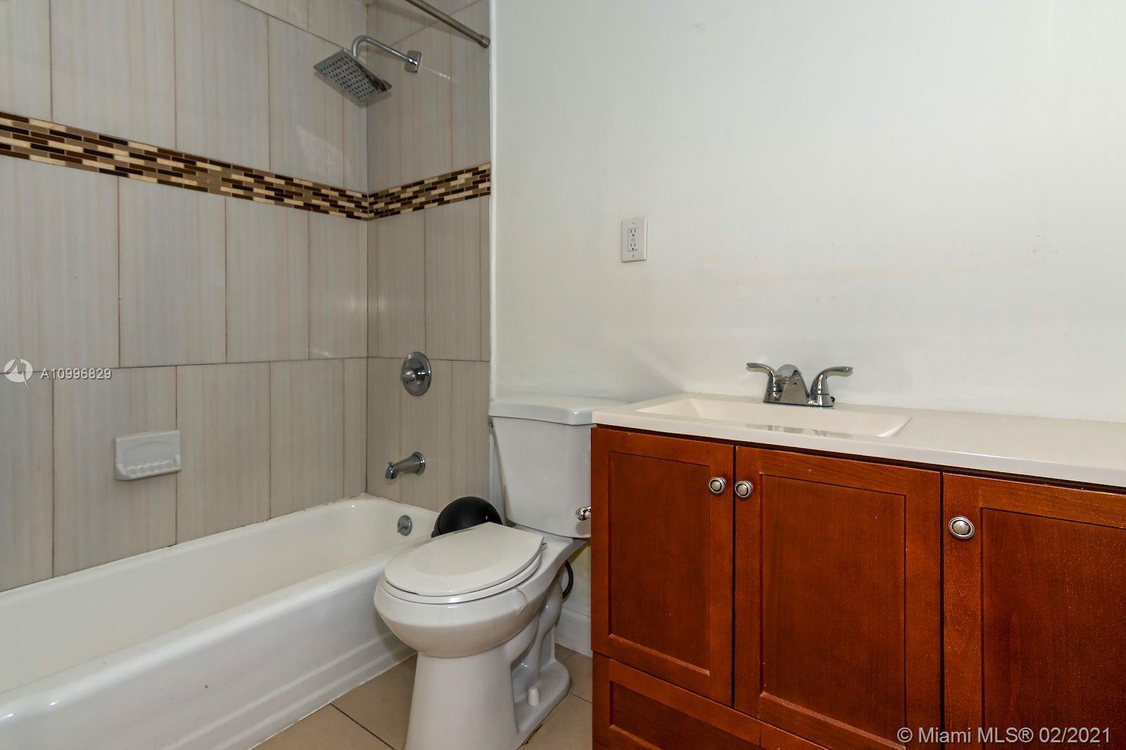 3829 East Shore Road Miramar, FL 33023 - Photo 8 of 14 a bathroom with a sink a toilet and shower