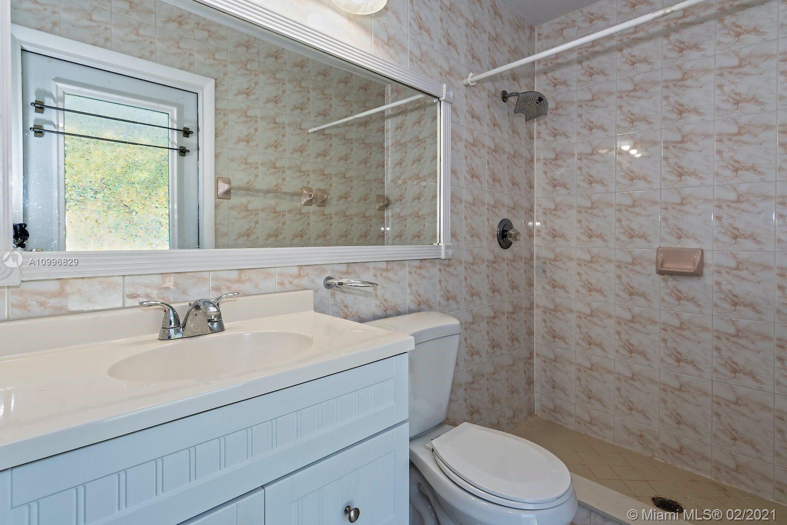 3829 East Shore Road Miramar, FL 33023 - Photo 10 of 14 a bathroom with a sink a toilet and shower