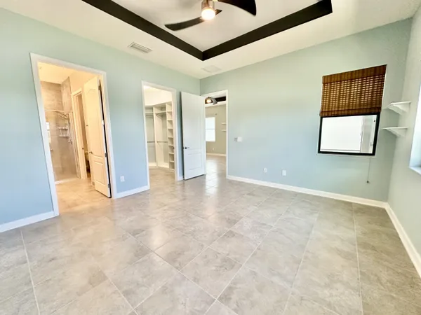 an empty room with windows and closet