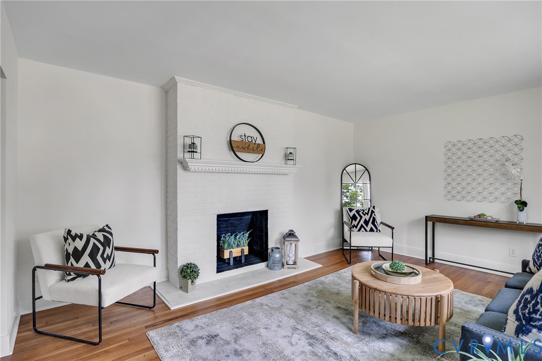 7709 Yolanda Road Henrico, VA 23229 - Photo 5 of 26 Living area featuring a brick fireplace and wood f