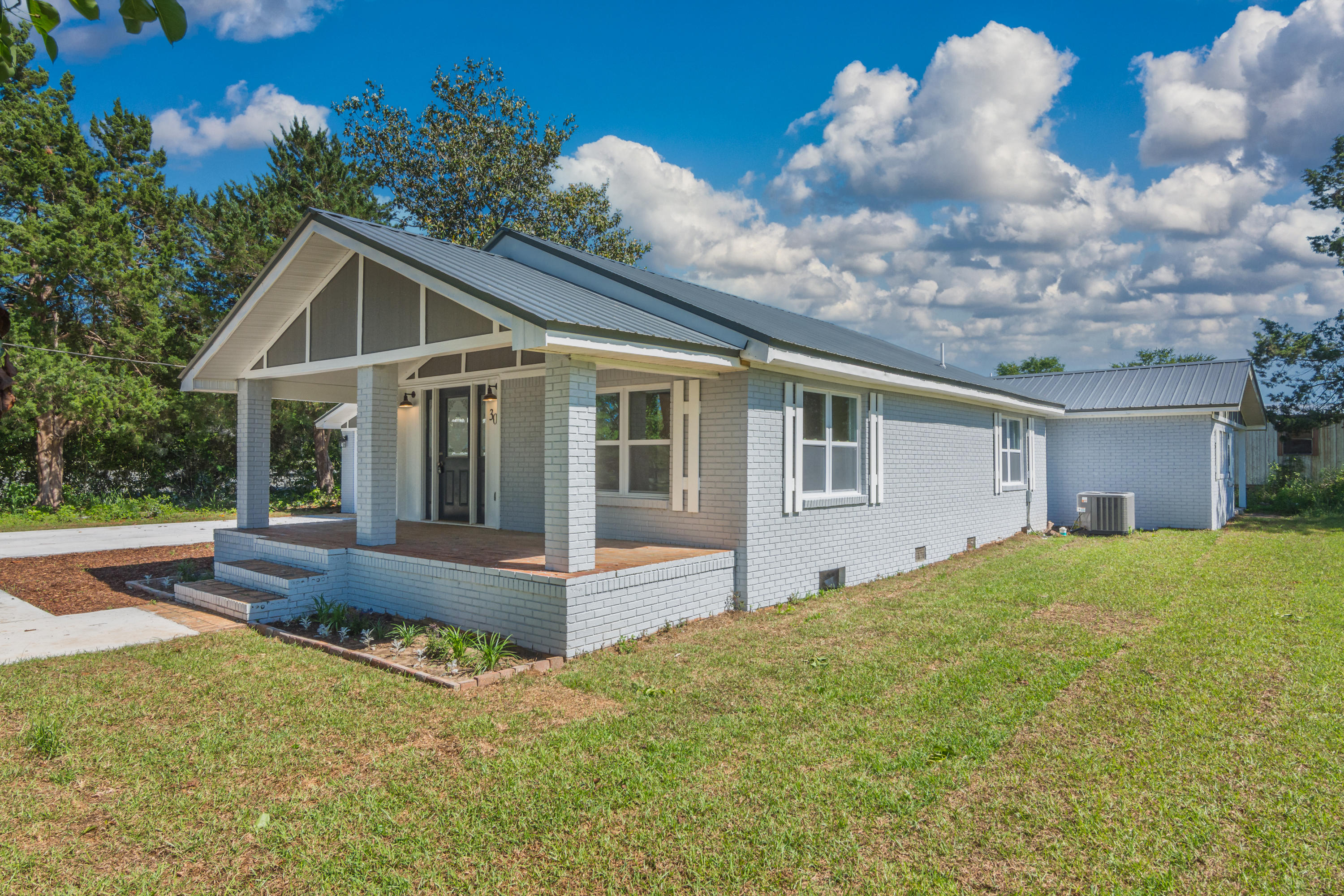 3032 Adams Road Crestview, FL 32536 - Photo 1 of 41 a front view of house with yard and trees in the background
