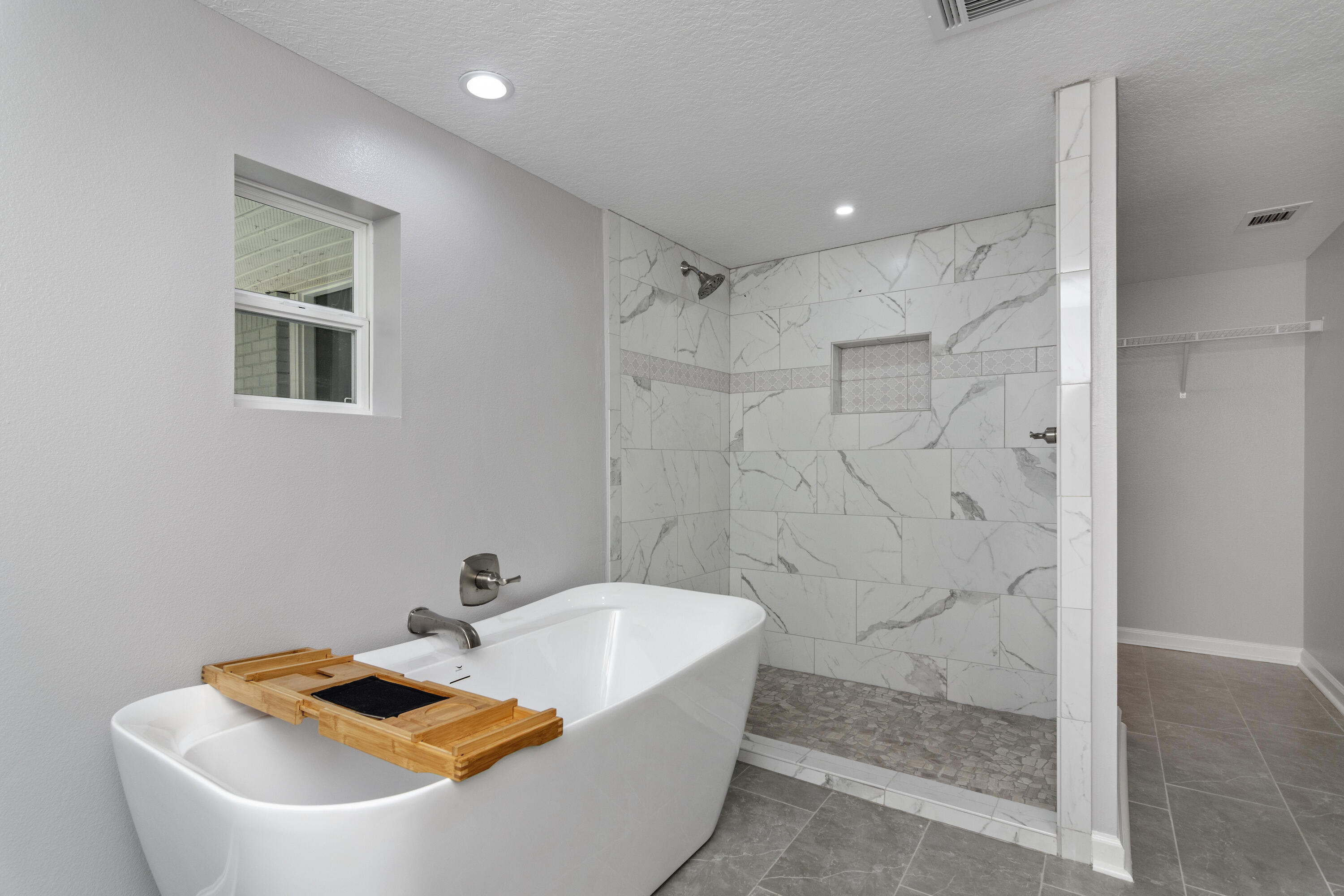 3032 Adams Road Crestview, FL 32536 - Photo 16 of 41 a bathroom with a tub and a shower