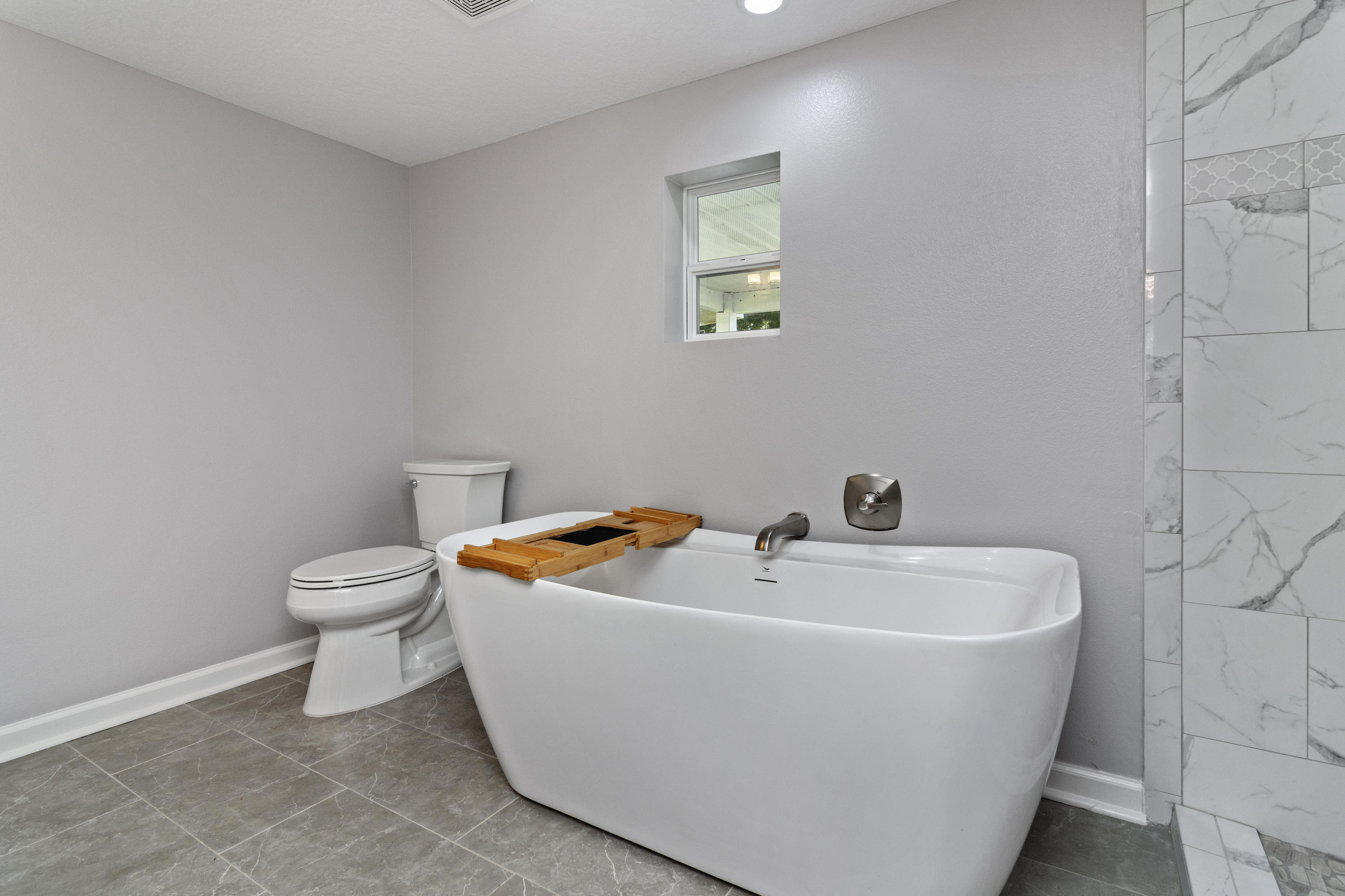 3032 Adams Road Crestview, FL 32536 - Photo 19 of 41 a white bath tub sitting next to a white toilet