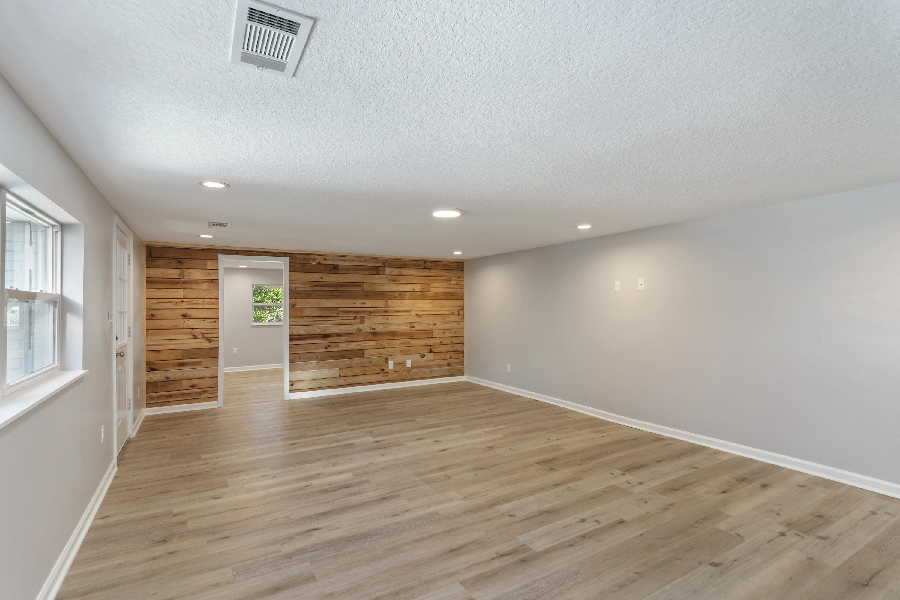 3032 Adams Road Crestview, FL 32536 - Photo 21 of 41 wooden floor in an empty room with a window
