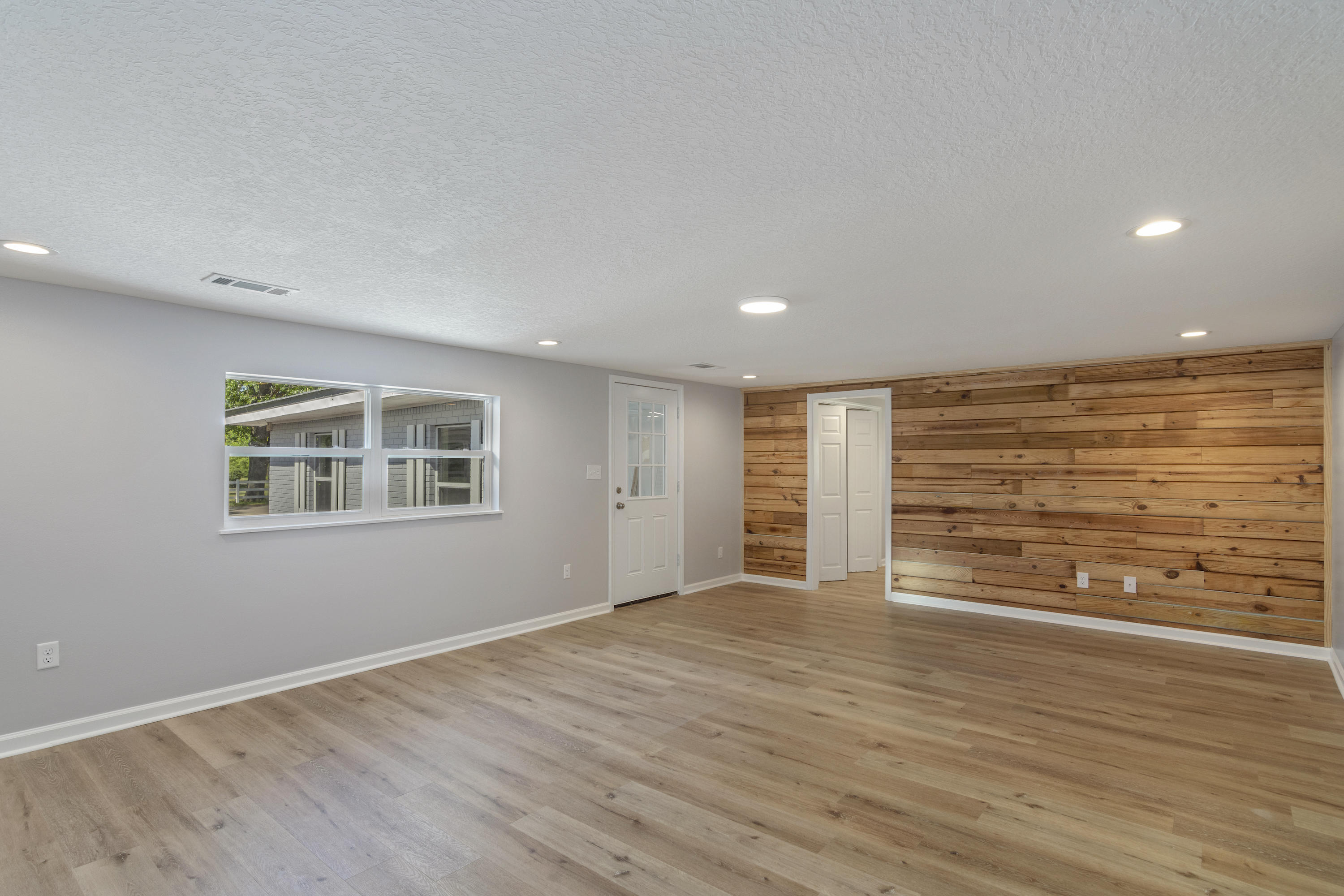 3032 Adams Road Crestview, FL 32536 - Photo 22 of 41 a view of an empty room with wooden floor and a window