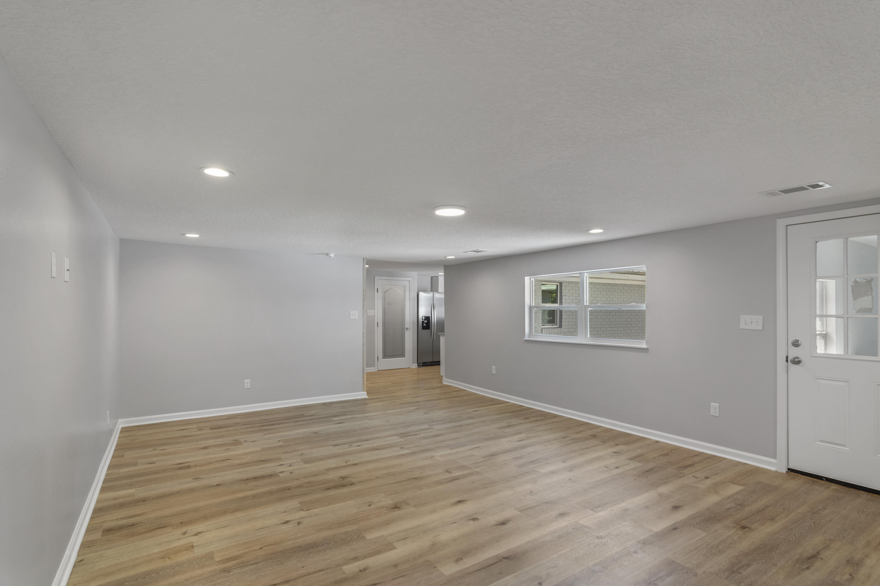 3032 Adams Road Crestview, FL 32536 - Photo 23 of 41 a view of an empty room with wooden floor and a window