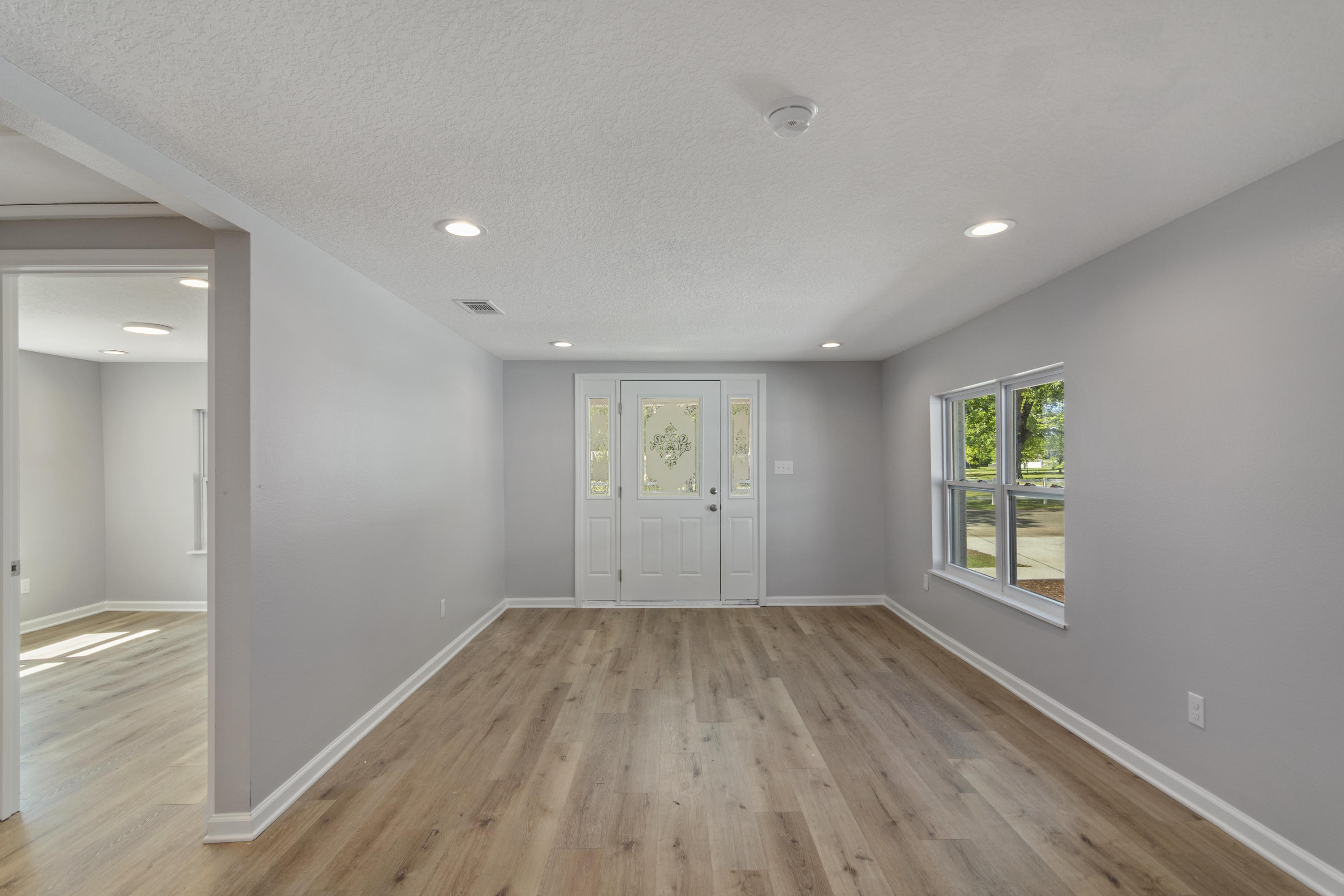 3032 Adams Road Crestview, FL 32536 - Photo 25 of 41 a view of an empty room with wooden floor and a window