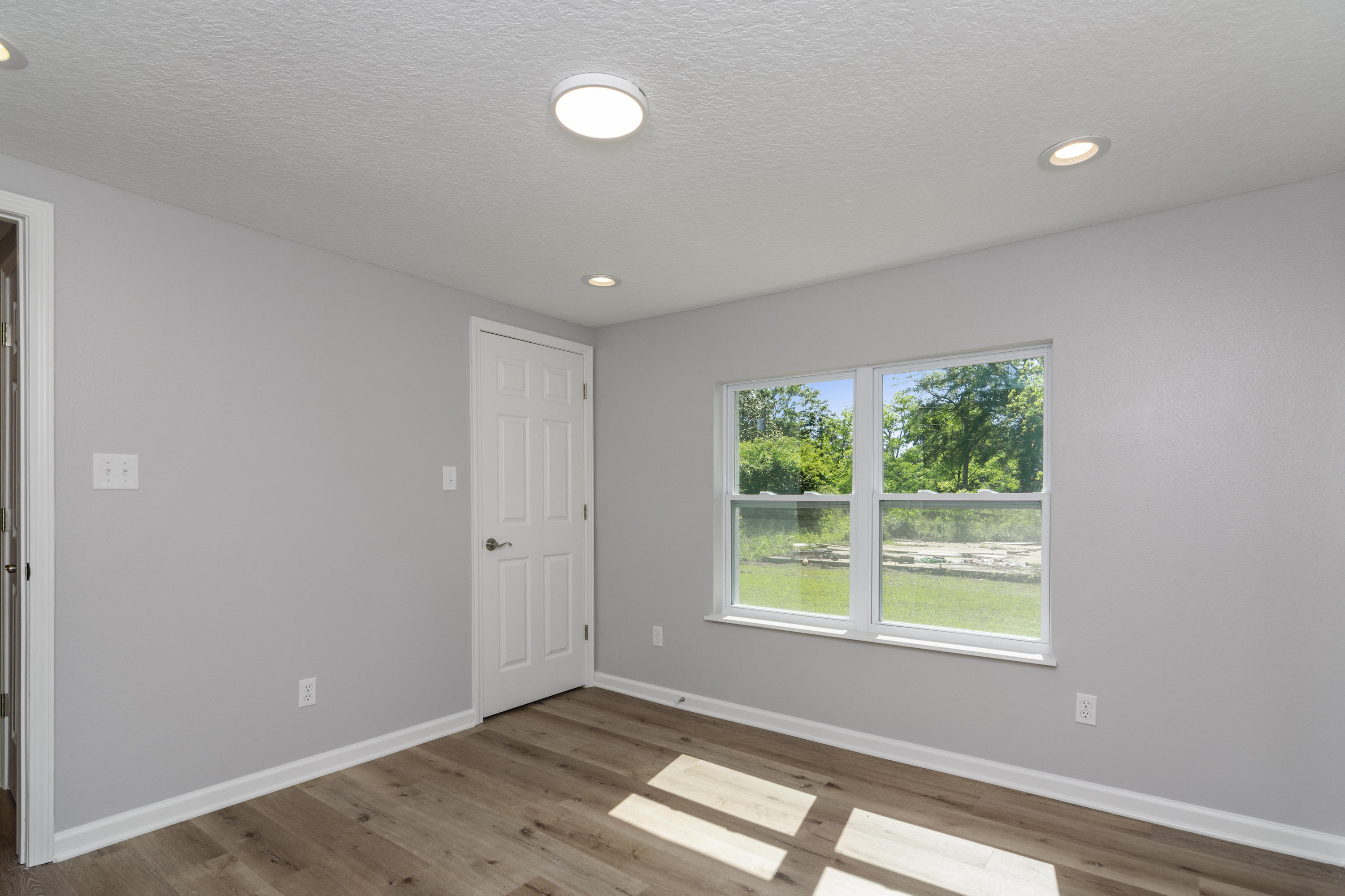 3032 Adams Road Crestview, FL 32536 - Photo 29 of 41 a view of an empty room with wooden floor and a window
