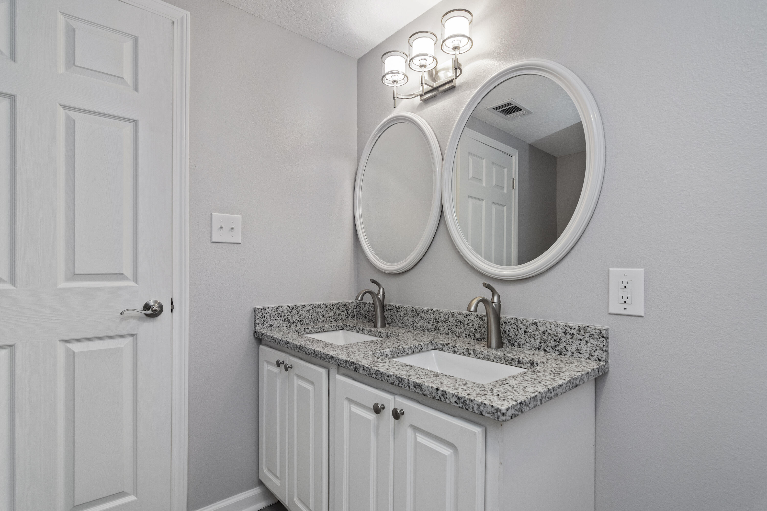 3032 Adams Road Crestview, FL 32536 - Photo 30 of 41 a bathroom with a granite countertop sink and a mirror