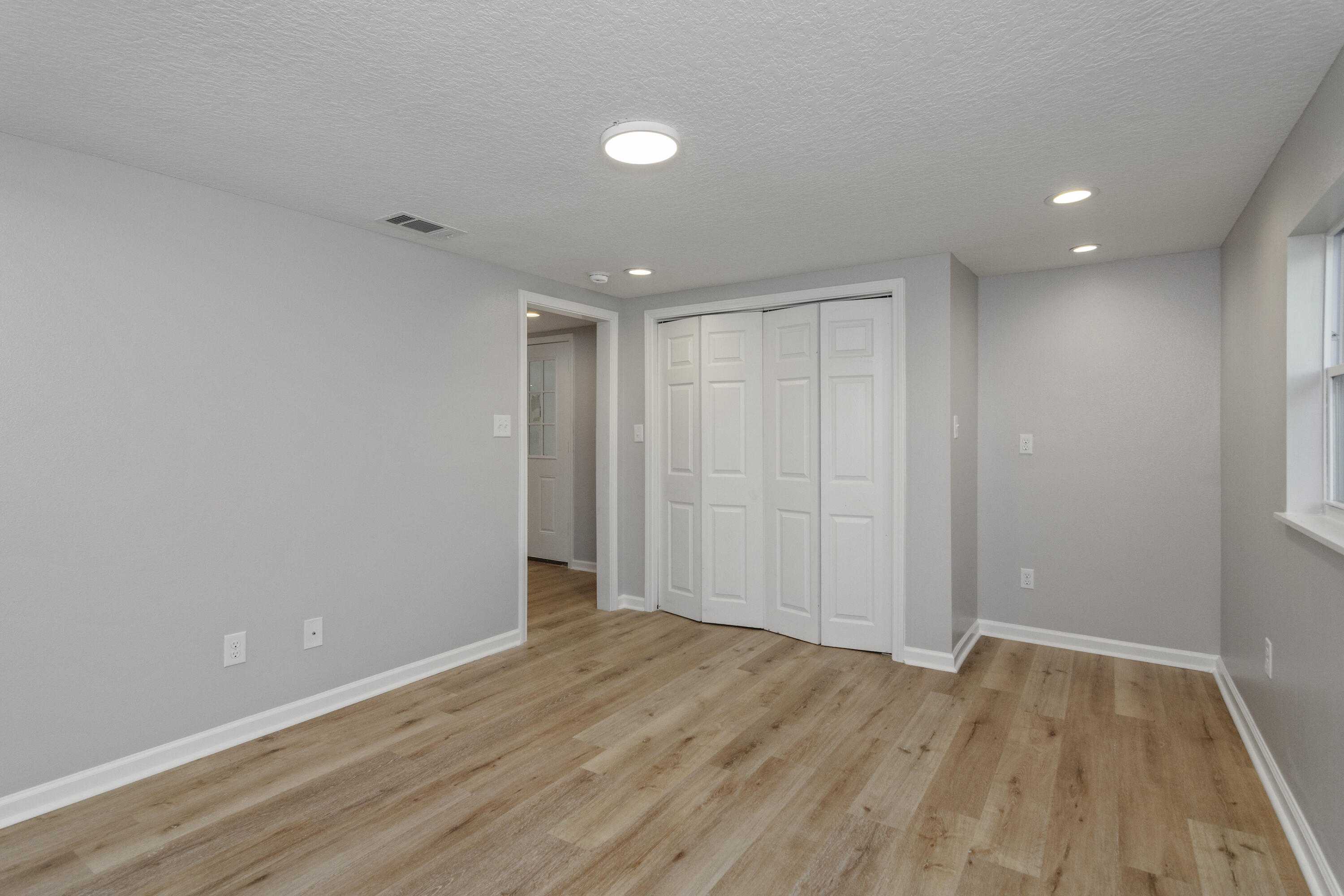 3032 Adams Road Crestview, FL 32536 - Photo 34 of 41 wooden floor in an empty room with a window