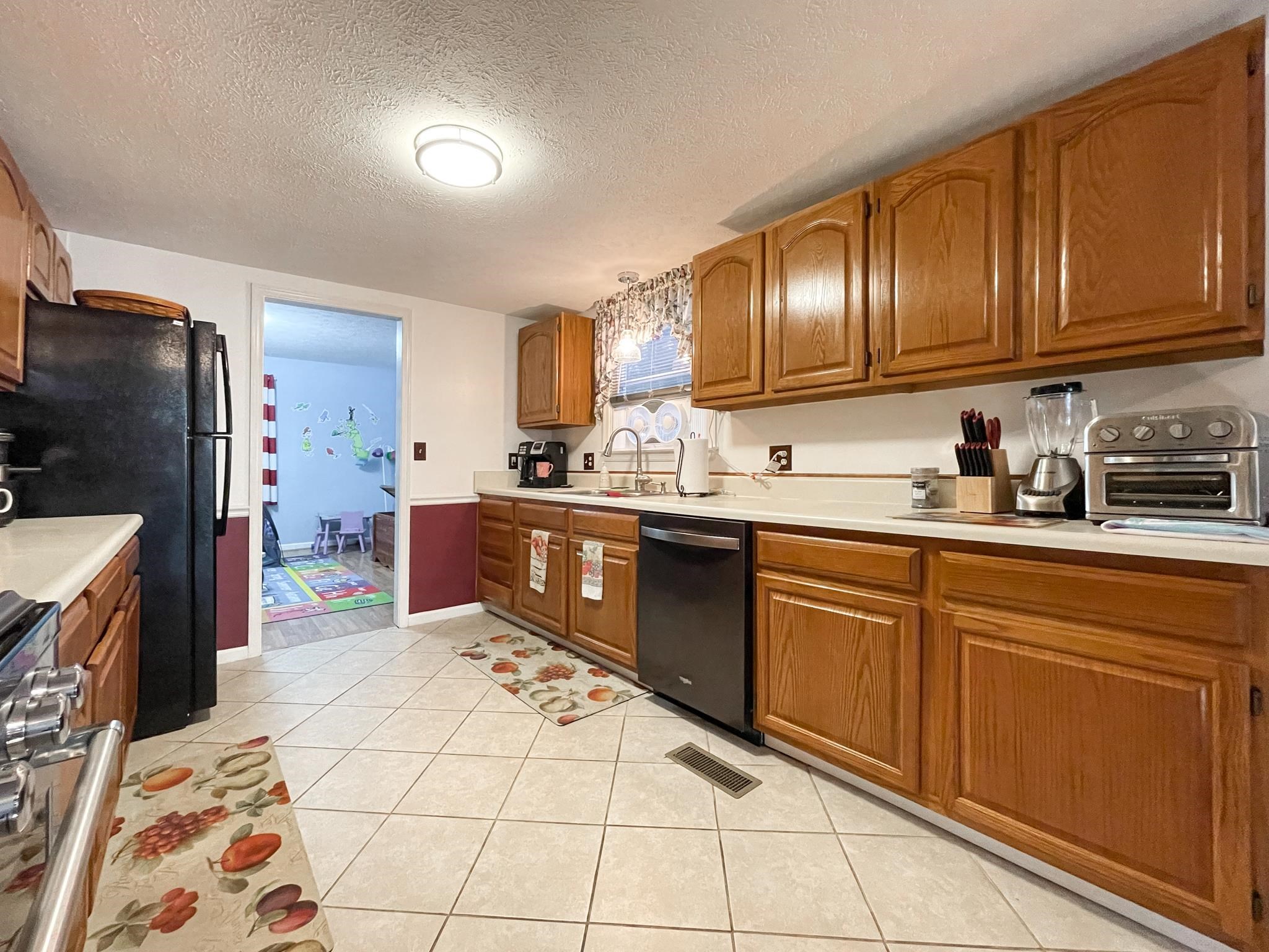 172 Beagle Gap Run Waynesboro, VA 22980 - Photo 16 of 32 a kitchen with stainless steel appliances granite countertop a sink stove and refrigerator