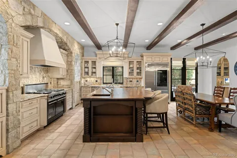 a kitchen with stainless steel appliances granite countertop a stove and cabinets