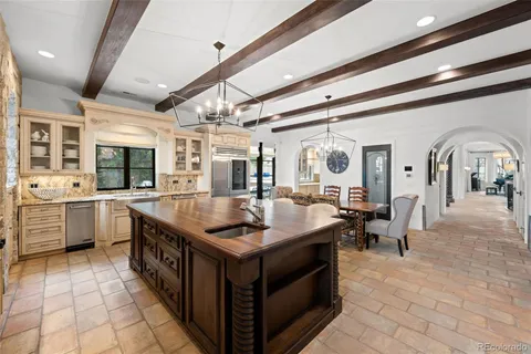 a large living room with granite countertop a sink and a refrigerator