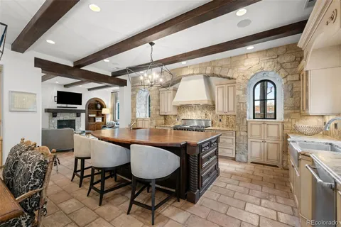 a kitchen with stainless steel appliances granite countertop a sink and a refrigerator
