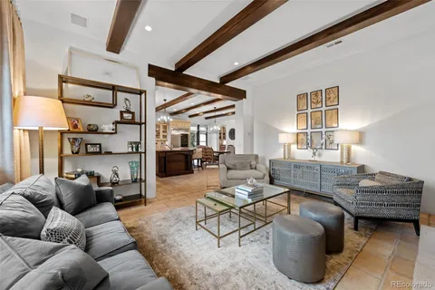 a living room with furniture a rug and a window