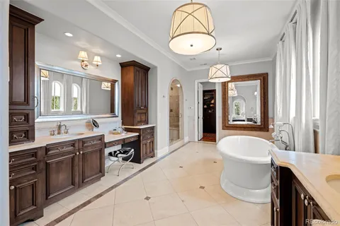 a spacious bathroom with a sink a vanity a mirror and a bathtub