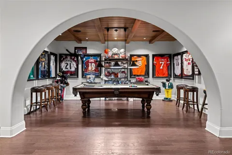 a dining room with furniture entryway and wooden floor