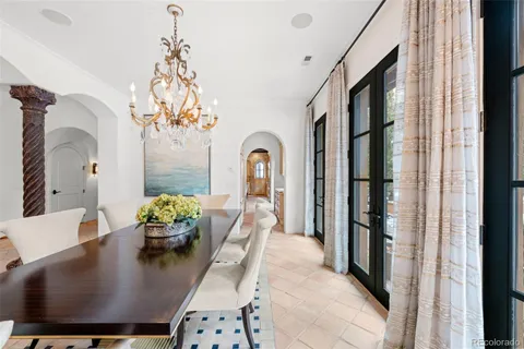 a living room with dining table furniture and a chandelier
