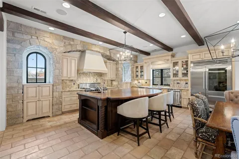 a large kitchen with a table and chairs