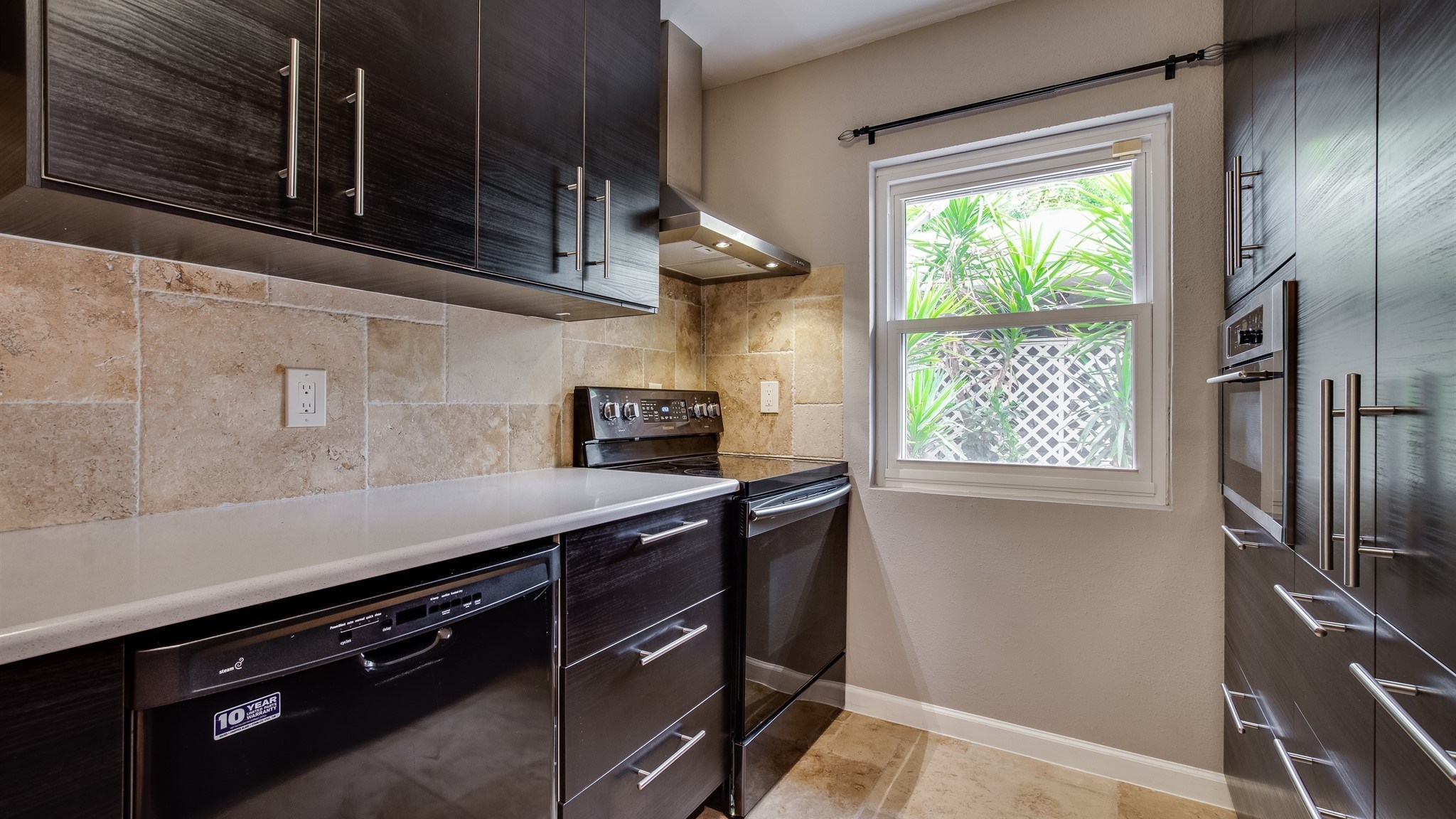 12615 Huntingwick Drive Houston, TX 77024 - Photo 12 of 35 a kitchen with stainless steel appliances a sink stove and cabinets