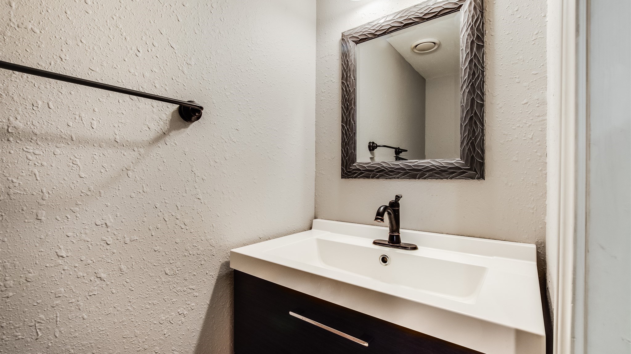 12615 Huntingwick Drive Houston, TX 77024 - Photo 17 of 35 a bathroom with a sink a mirror and vanity