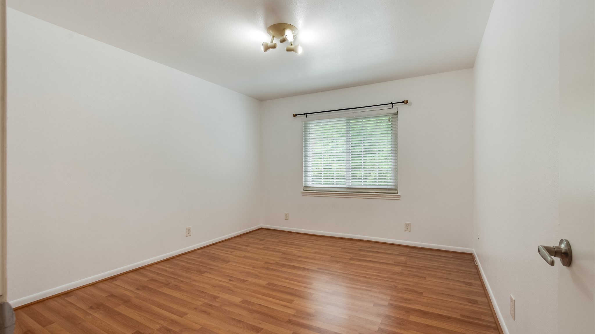 12615 Huntingwick Drive Houston, TX 77024 - Photo 19 of 35 an empty room with wooden floor and chandelier fan