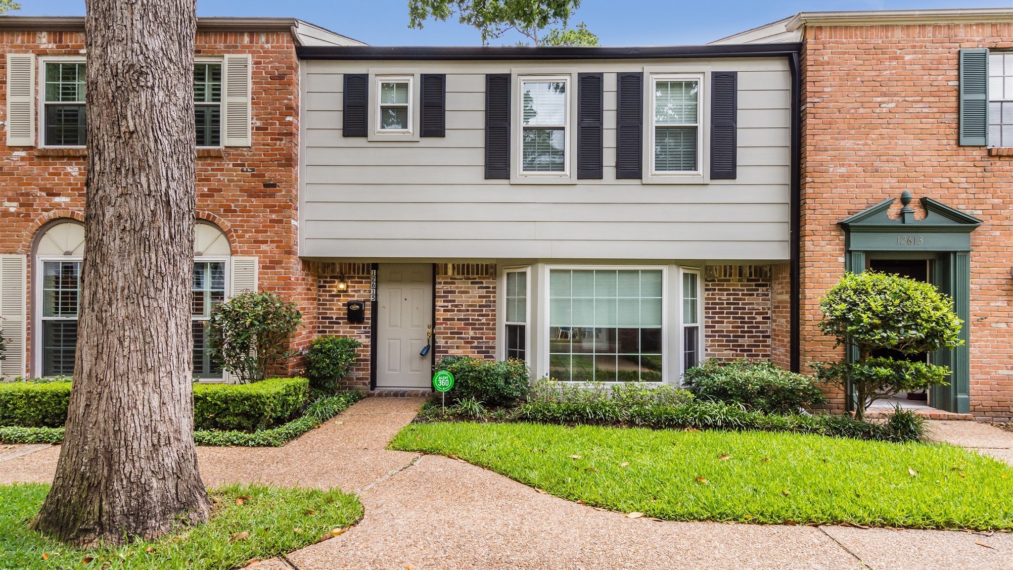 12615 Huntingwick Drive Houston, TX 77024 - Photo 2 of 35 a front view of a house with garden
