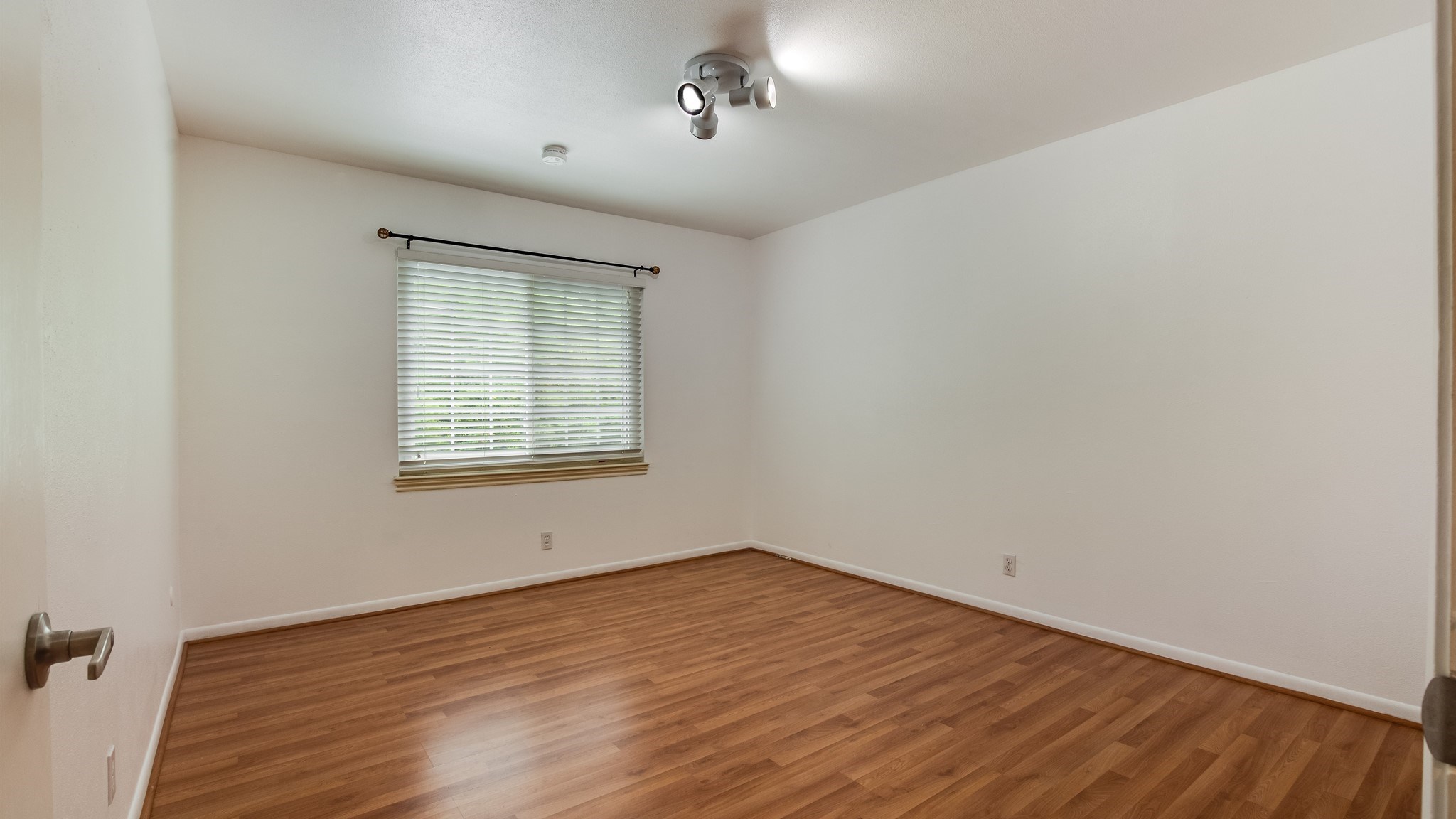 12615 Huntingwick Drive Houston, TX 77024 - Photo 21 of 35 an empty room with wooden floor and windows