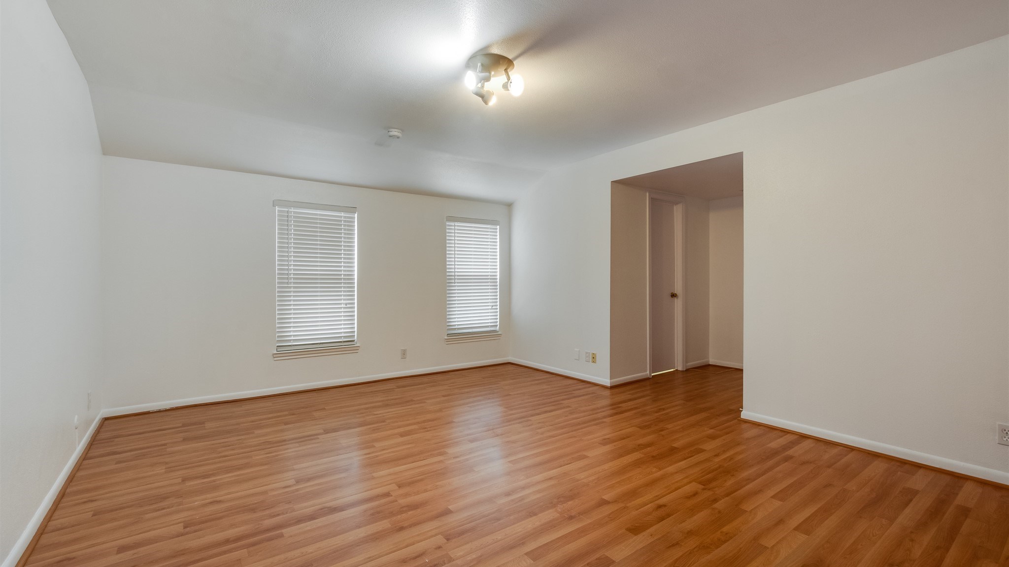 12615 Huntingwick Drive Houston, TX 77024 - Photo 23 of 35 a view of an empty room with wooden floor and a window