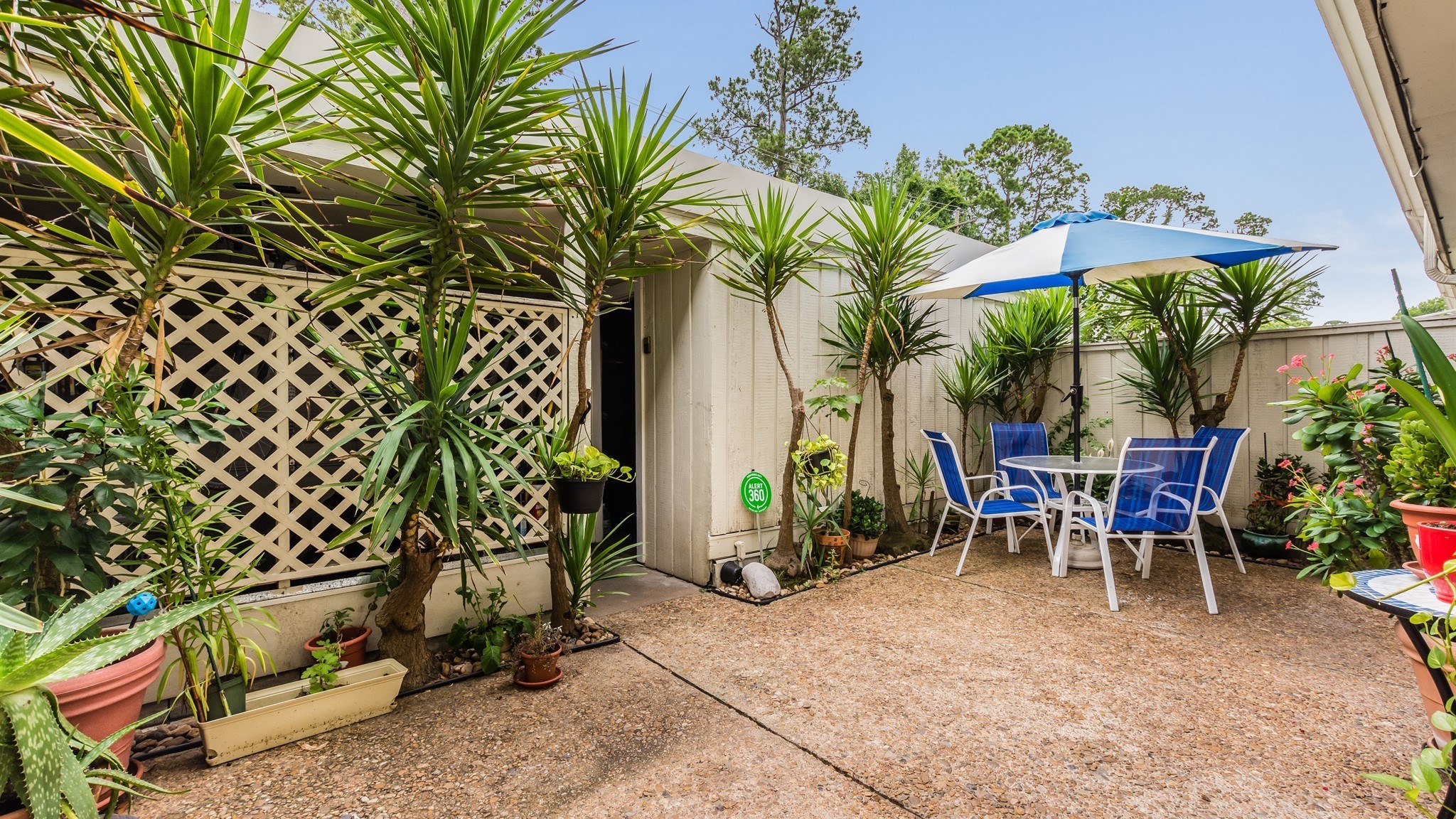 12615 Huntingwick Drive Houston, TX 77024 - Photo 34 of 35 a view of a patio with table and chairs and potted plants