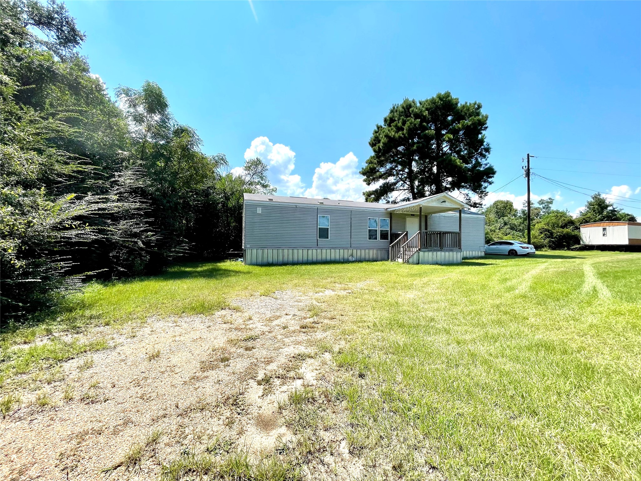 71 Woodrow Street Coldspring, TX 77331 - Photo 20 of 23 a view of a house with a yard