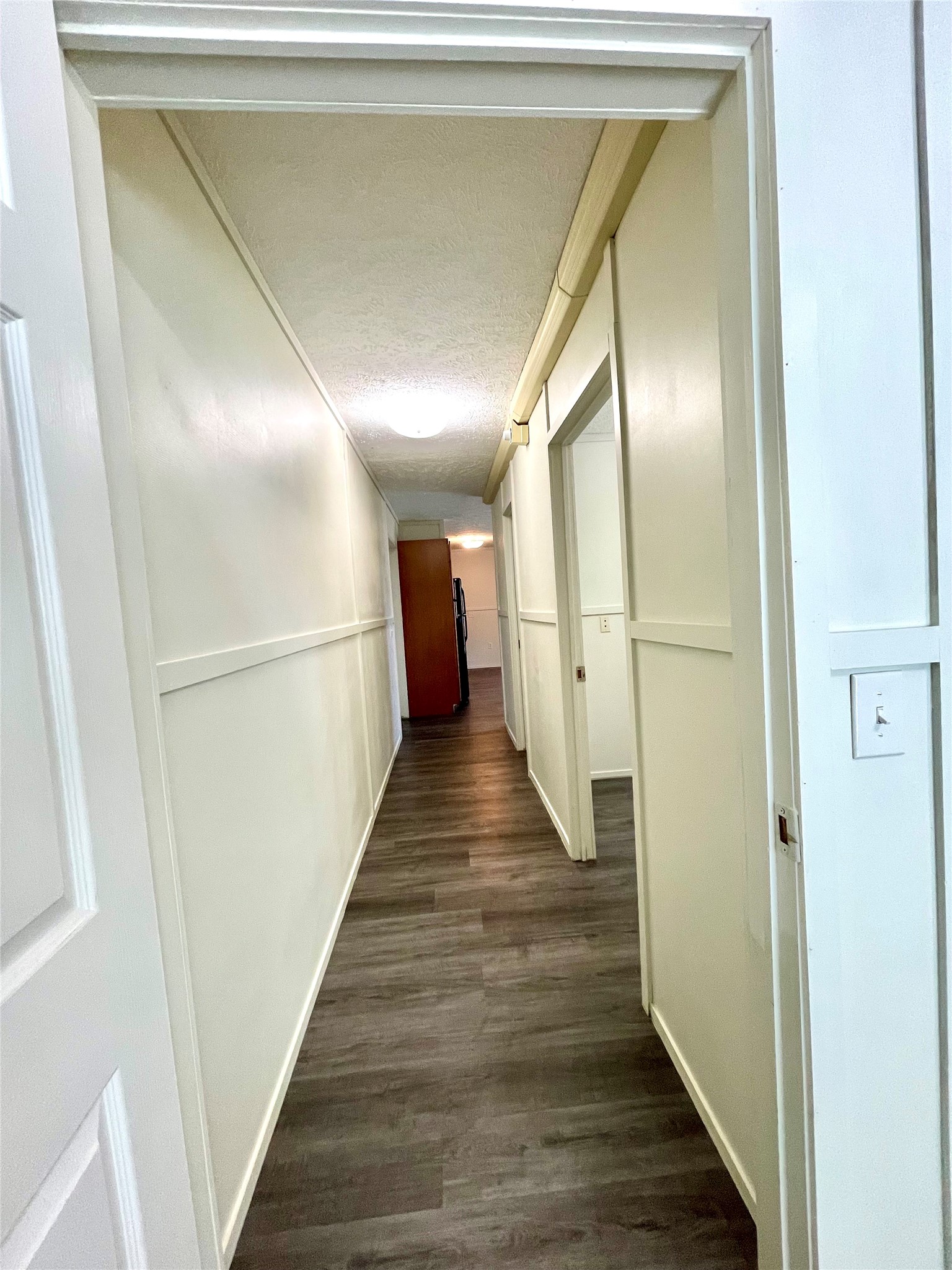 71 Woodrow Street Coldspring, TX 77331 - Photo 2 of 23 a view of a hallway with wooden floor and staircase