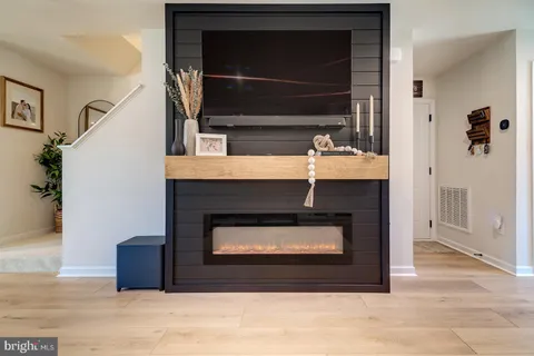 a room with fireplace and a wooden floor