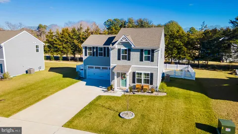 a view of swimming pool with outdoor seating and house in the background