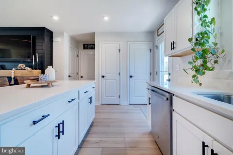 a spacious bathroom with a double vanity sink a large mirror and a shower