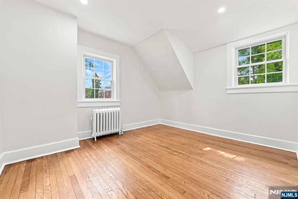 867 River Road Teaneck, NJ 07666 - Photo 21 of 45 an empty room with wooden floor and windows