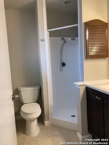 a view of a livingroom with a fireplace a sink a microwave and a chandelier