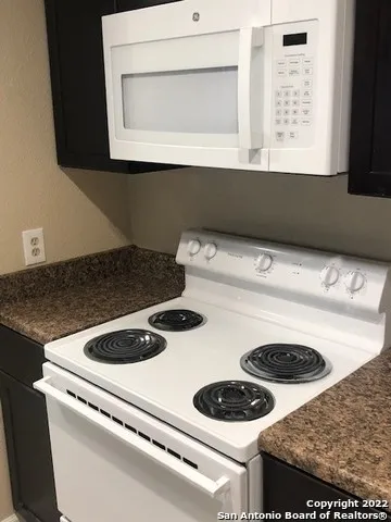 a kitchen with a stove and a microwave