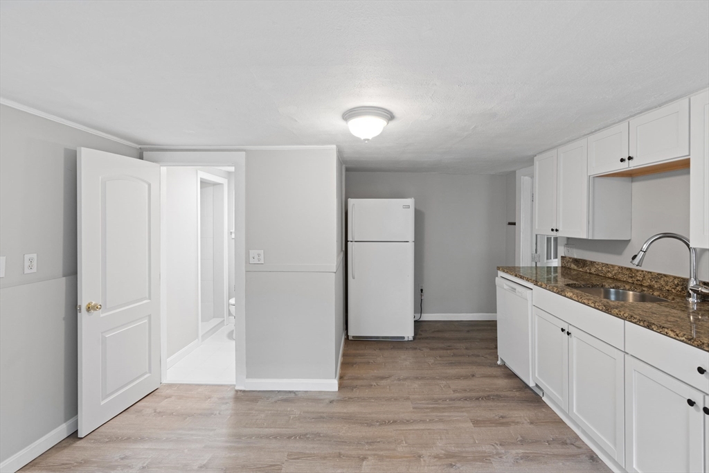 95 South Main Street, Unit B Andover, MA 01810 - Photo 14 of 34 a kitchen with stainless steel appliances granite countertop a refrigerator and a sink