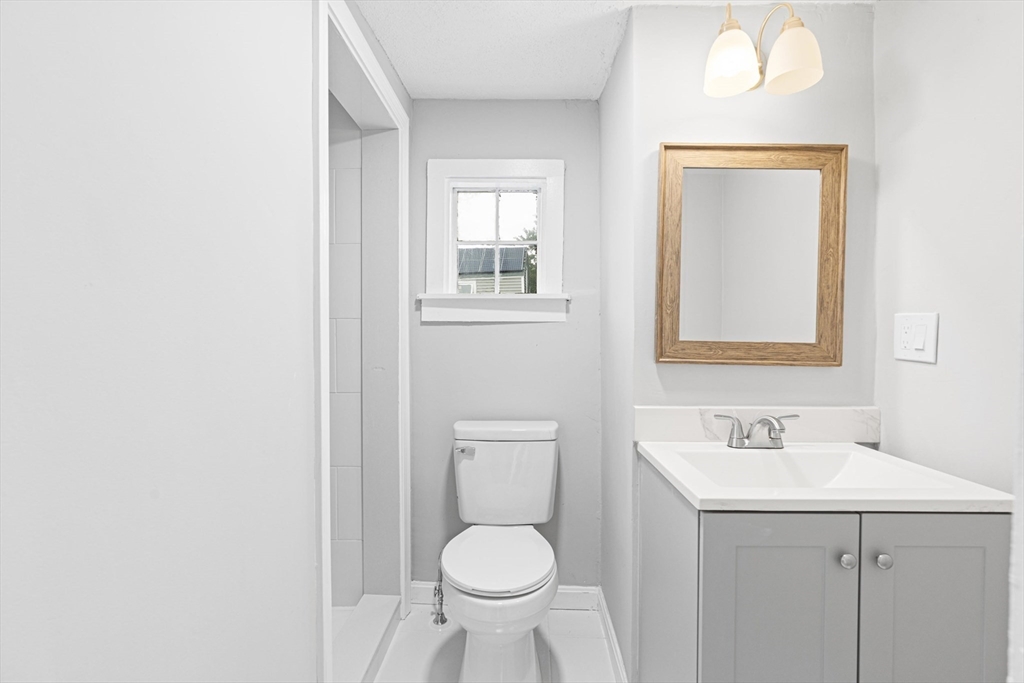 95 South Main Street, Unit B Andover, MA 01810 - Photo 15 of 34 a bathroom with a toilet sink and mirror