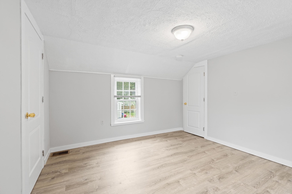 95 South Main Street, Unit B Andover, MA 01810 - Photo 22 of 34 an empty room with wooden floor and windows