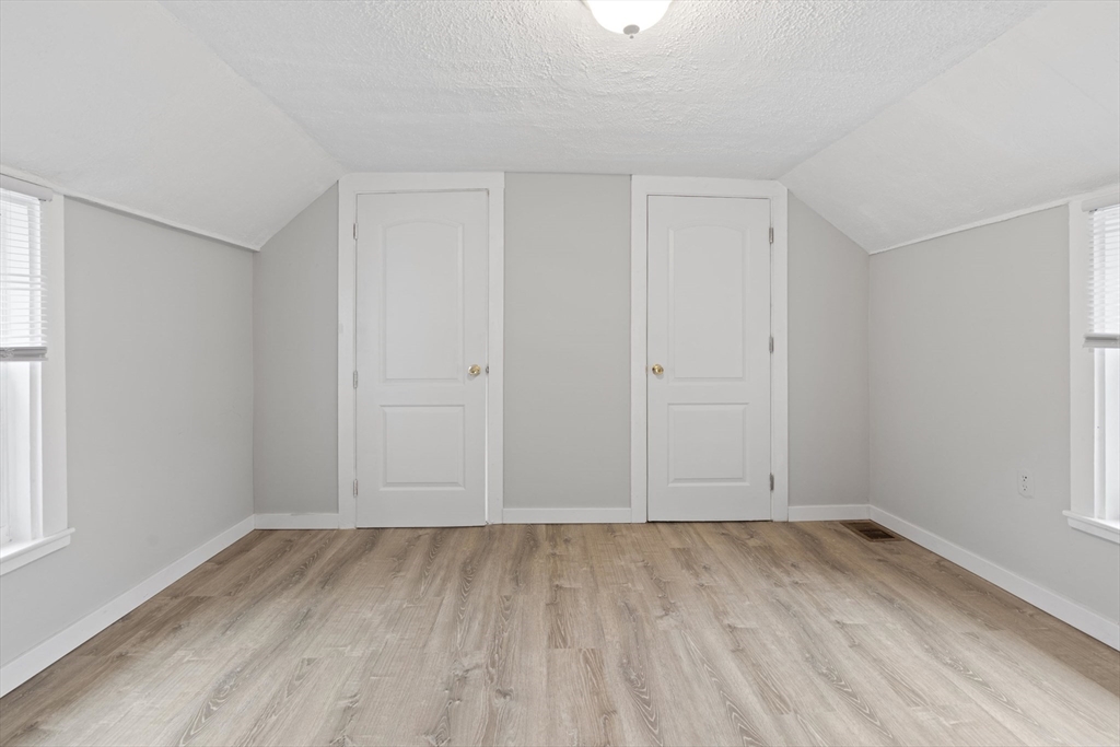 95 South Main Street, Unit B Andover, MA 01810 - Photo 24 of 34 an empty room with wooden floor and windows
