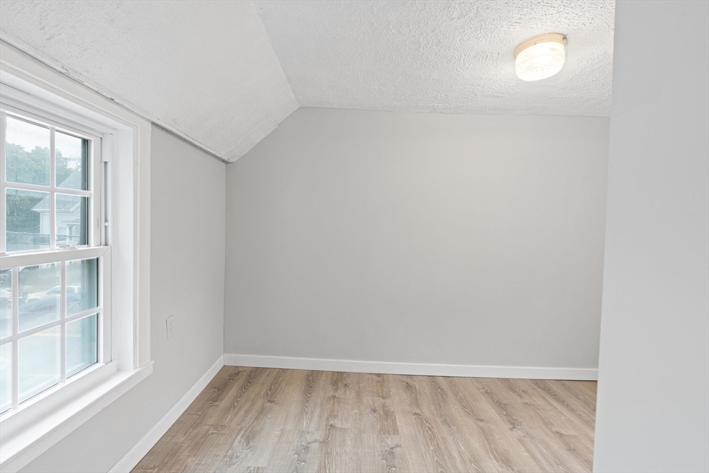 95 South Main Street, Unit B Andover, MA 01810 - Photo 25 of 34 a view of an empty room with a window and wooden floor
