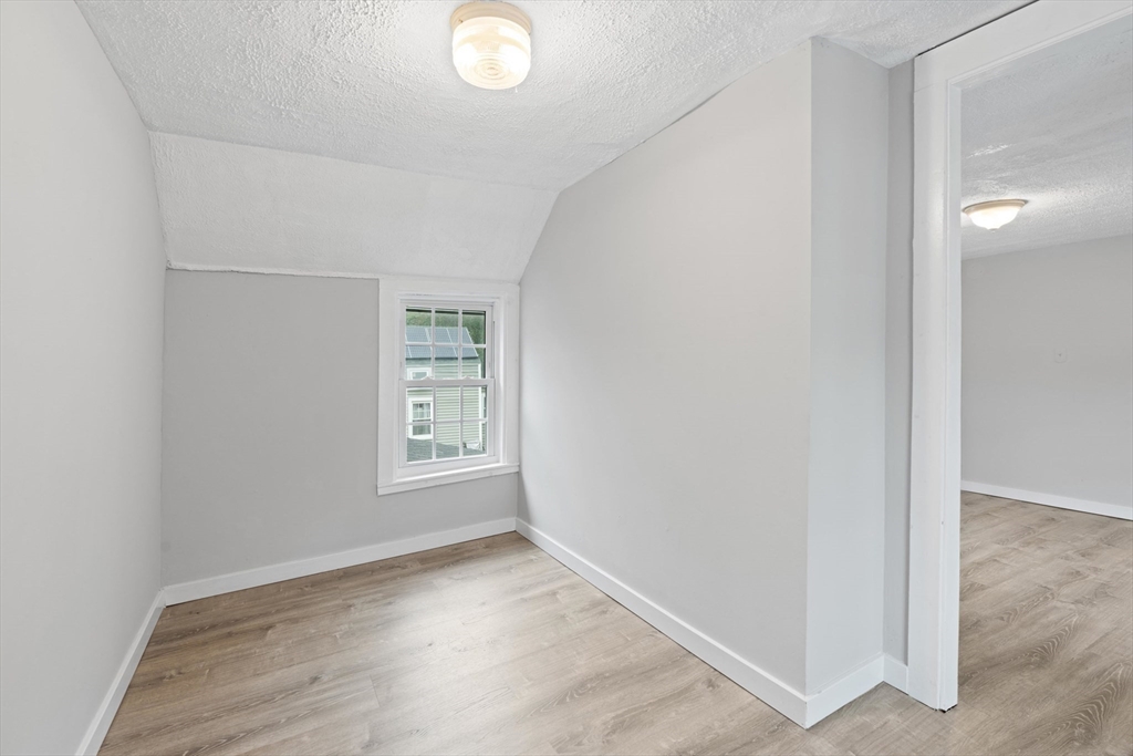 95 South Main Street, Unit B Andover, MA 01810 - Photo 26 of 34 a view of an empty room with wooden floor and a window