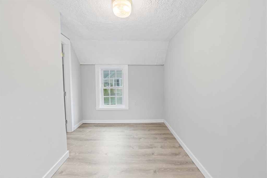 95 South Main Street, Unit B Andover, MA 01810 - Photo 28 of 34 an empty room with wooden floor and windows