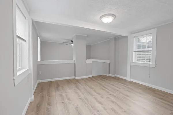 an empty room with windows and closet