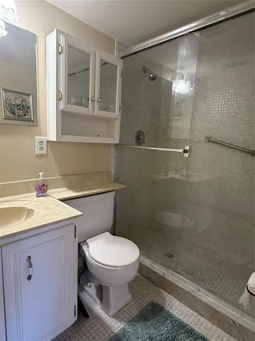 a bathroom with a toilet a sink and shower